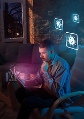 Image showing Shocked, upset and sad man using gadgets to get information of coronavirus pandemic spread