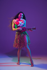 Image showing Fabulous Cinco de Mayo female dancer on purple studio background in neon light