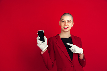 Image showing Portrait of young caucasian bald woman on red background