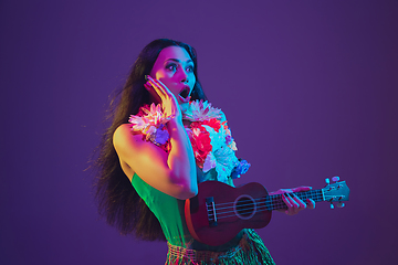 Image showing Fabulous Cinco de Mayo female dancer on purple studio background in neon light