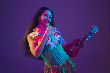 Image showing Fabulous Cinco de Mayo female dancer on purple studio background in neon light