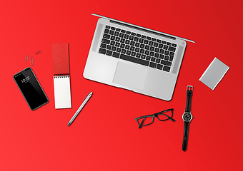 Image showing Office desk mockup top view isolated on red