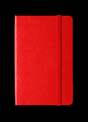 Image showing Red closed notebook isolated on black