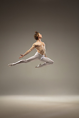 Image showing Young and graceful ballet dancer isolated on studio background. Art, motion, action, flexibility, inspiration concept.