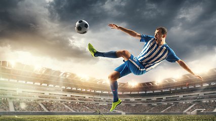 Image showing Male football or soccer player at stadium - motion, action, activity concept