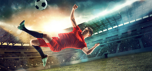 Image showing Male football or soccer player at stadium - motion, action, activity concept