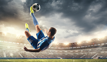 Image showing Male football or soccer player at stadium - motion, action, activity concept