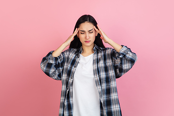 Image showing Caucasian woman\'s portrait isolated on coral pink studio background with copyspace