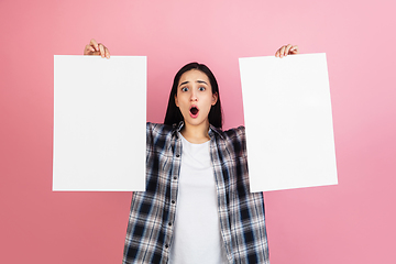 Image showing Caucasian woman\'s portrait isolated on coral pink studio background with copyspace