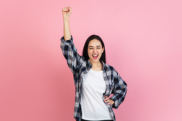 Image showing Caucasian woman\'s portrait isolated on coral pink studio background with copyspace