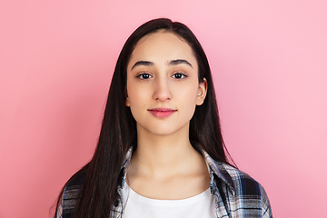 Image showing Caucasian woman\'s portrait isolated on coral pink studio background with copyspace