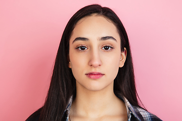 Image showing Caucasian woman\'s portrait isolated on coral pink studio background with copyspace