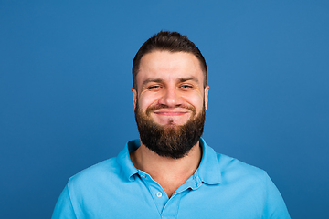 Image showing Caucasian man\'s portrait isolated on blue studio background with copyspace