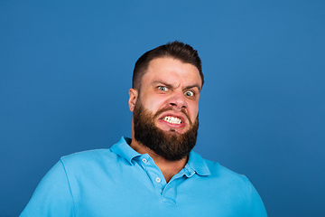 Image showing Caucasian man\'s portrait isolated on blue studio background with copyspace