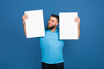 Image showing Caucasian man\'s portrait isolated on blue studio background with copyspace