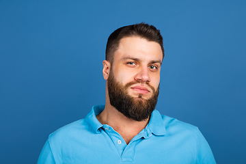 Image showing Caucasian man\'s portrait isolated on blue studio background with copyspace