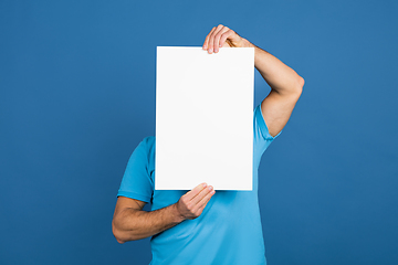 Image showing Caucasian man\'s portrait isolated on blue studio background with copyspace