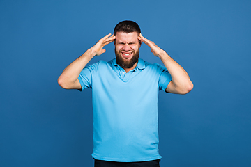 Image showing Caucasian man\'s portrait isolated on blue studio background with copyspace