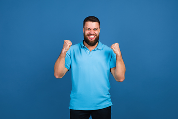 Image showing Caucasian man\'s portrait isolated on blue studio background with copyspace