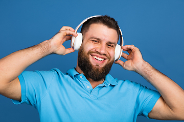 Image showing Caucasian man\'s portrait isolated on blue studio background with copyspace