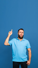 Image showing Caucasian man\'s portrait isolated on blue studio background with copyspace