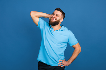 Image showing Caucasian man\'s portrait isolated on blue studio background with copyspace