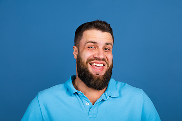 Image showing Caucasian man\'s portrait isolated on blue studio background with copyspace