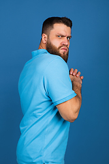 Image showing Caucasian man\'s portrait isolated on blue studio background with copyspace