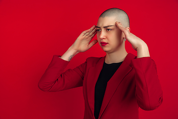 Image showing Portrait of young caucasian bald woman on red background