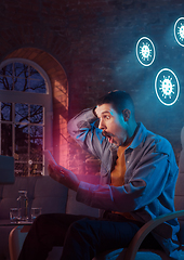 Image showing Shocked, upset and sad man using gadgets to get information of coronavirus pandemic spread