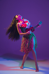 Image showing Fabulous Cinco de Mayo female dancer on purple studio background in neon light