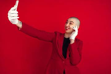 Image showing Portrait of young caucasian bald woman on red background