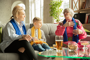 Image showing Excited family watching football, sport match at home, grandma, mother and son