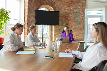 Image showing Business young caucasian woman in modern office with team