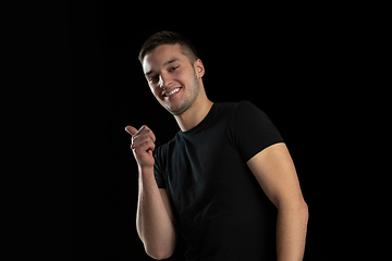 Image showing Monochrome portrait of young caucasian man on black studio background