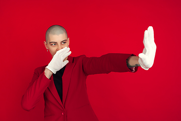 Image showing Portrait of young caucasian bald woman on red background