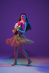 Image showing Fabulous Cinco de Mayo female dancer on purple studio background in neon light