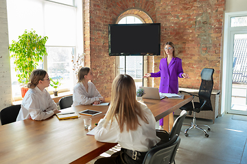 Image showing Business young caucasian woman in modern office with team