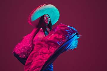 Image showing Fabulous Cinco de Mayo female dancer on purple studio background in neon light