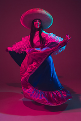 Image showing Fabulous Cinco de Mayo female dancer on purple studio background in neon light