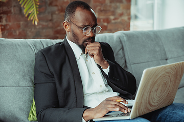 Image showing Businessman or student working from home while being isolated or keep quarantine \'cause of coronavirus COVID-19