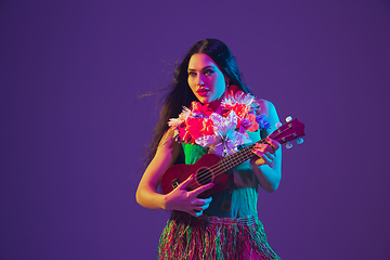 Image showing Fabulous Cinco de Mayo female dancer on purple studio background in neon light