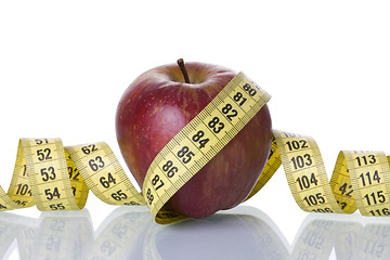 Image showing Red apple with a measure tape