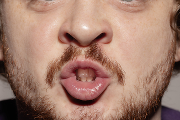 Image showing Close-up male mouth illustrating emotions. Cosmetology, dentistry and beauty care, facial expression