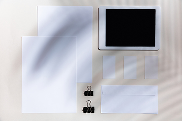 Image showing Creative and cozy workplace at home office, inspirational mock up with plant shadows on table surface