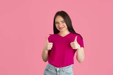 Image showing Monochrome portrait of young caucasian brunette woman on pink background
