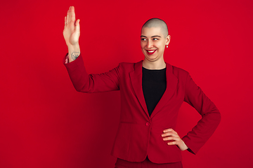 Image showing Portrait of young caucasian bald woman on red background