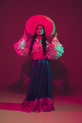 Image showing Fabulous Cinco de Mayo female dancer on purple studio background in neon light