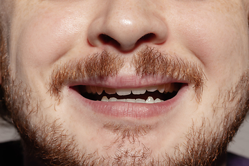 Image showing Close-up male mouth illustrating emotions. Cosmetology, dentistry and beauty care, facial expression