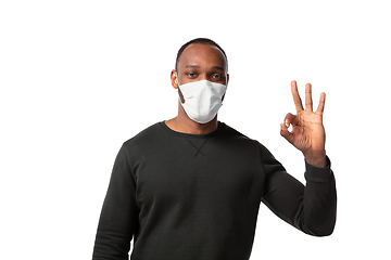 Image showing How coronavirus changed our lives. Young man wearing face mask to stop spreading on white background